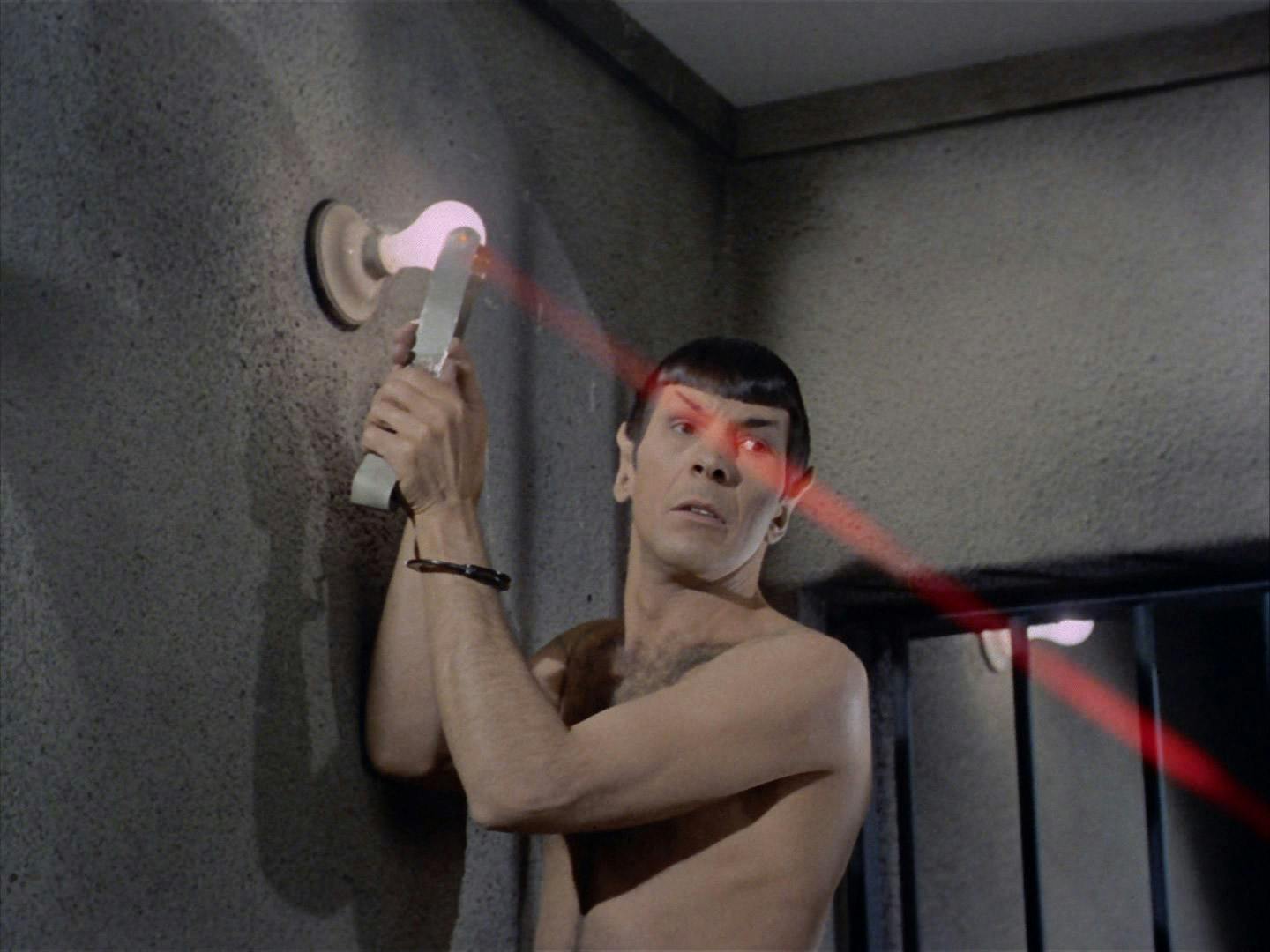 A shirtless Spock, boosted up by Kirk, generates a laser beam using the metal bed post and their cell's light fixture to spring a jail break in 'Patterns of Force'