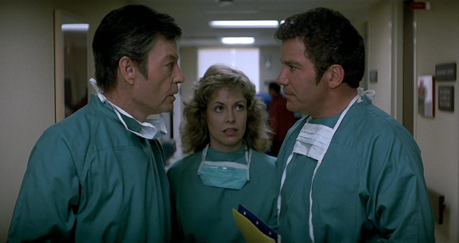 Disguised as doctors at a hospital, Dr. Gillian Taylor stands between McCoy and Kirk in The Voyage Home