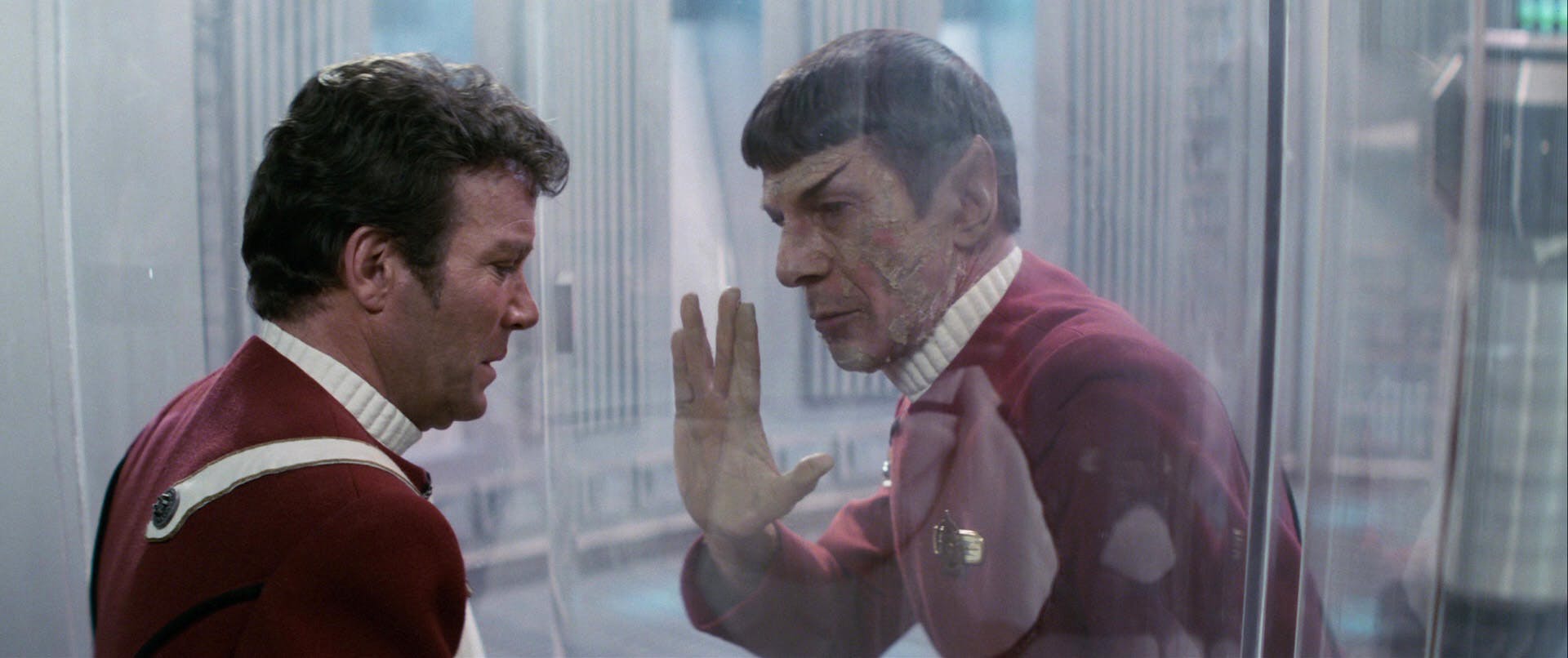 Spock sacrifices himself and says his farewell to his friend Kirk while raising the Vulcan salute to the glass in Star Trek II: The Wrath of Khan