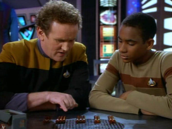 Chief O'Brien and Jake Sisko identify isolinear rods on a table in the replimat in 'Shadowplay'