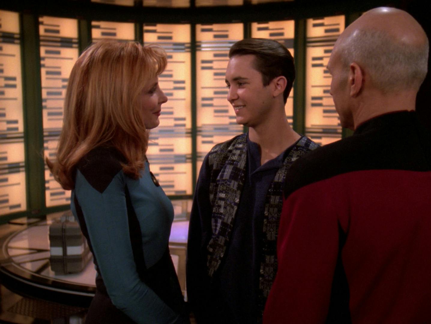 Wesley Crusher bids farewell with Beverly Crusher and Jean-Luc Picard while in the transporter room on the Enterprise-D in 'Journey's End'