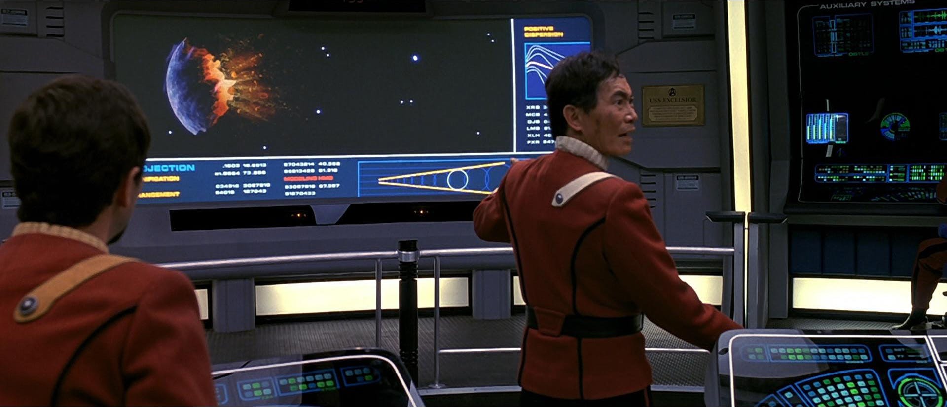 A shaken and disheveled Sulu looks over his shoulder following the shock of seeing the destroyed Praxis moon ripped in half on the Excelsior viewscreen in Star Trek VI: The Undiscovered Country 