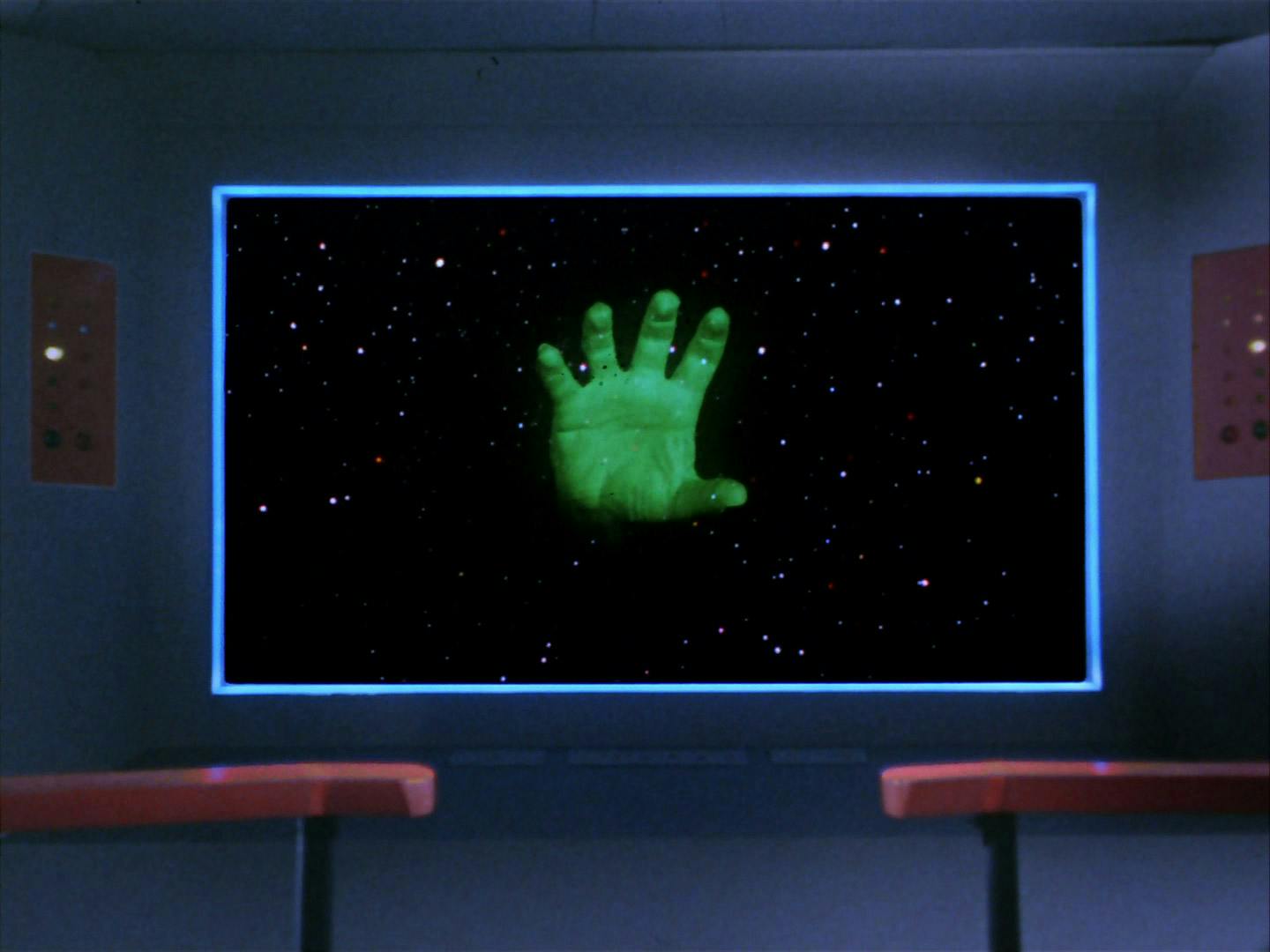 On the viewscreen of the Enterprise, a floating disembodied neon green hand approaches the starship in 'Who Mourns for Adonais'