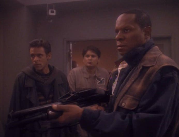 Trapped 300 years in the past, Julian Bashir and Ben Sisko holding a rifle agree to join the rebellion on Earth in 'Past Tense, Part I'