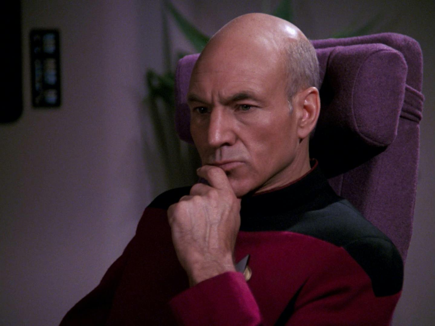 Close-up of Picard sitting at the head of the conference table in the Observation Lounge, pensive, with his chin resting on his left hand in 'The Defector'