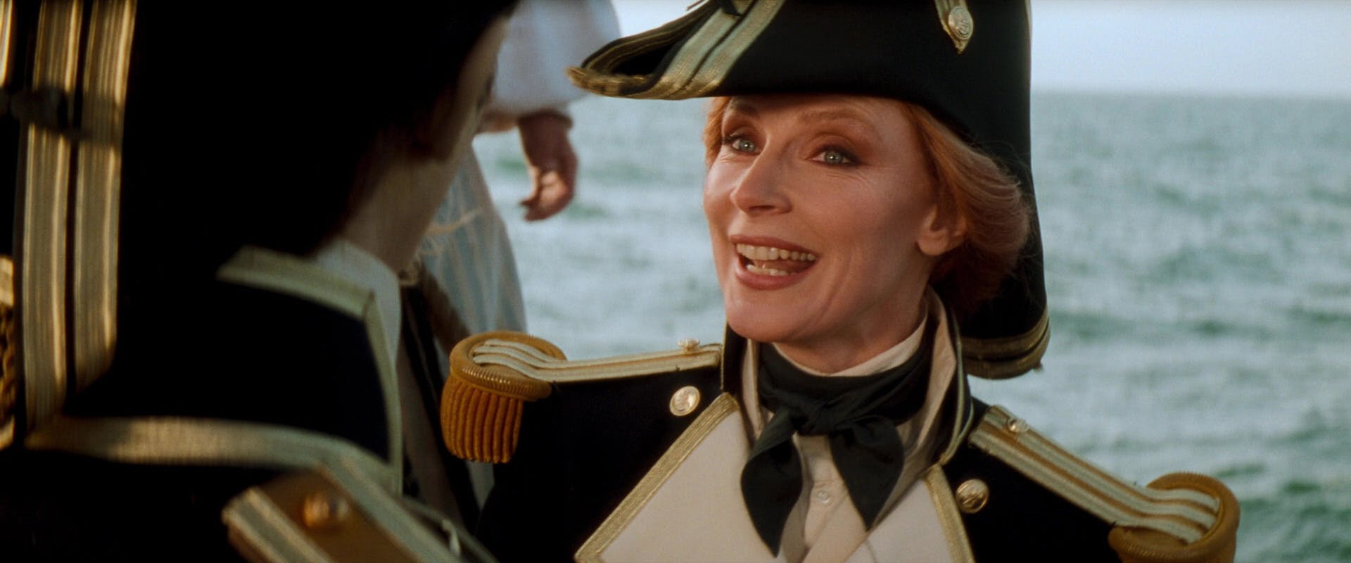 While wearing nautical garb on the deck of a ship, Dr. Beverly Crusher explains the playful humor of Worf falling into icy waters mere moments before Data pushes her over the ship's ledge in Star Trek Generations