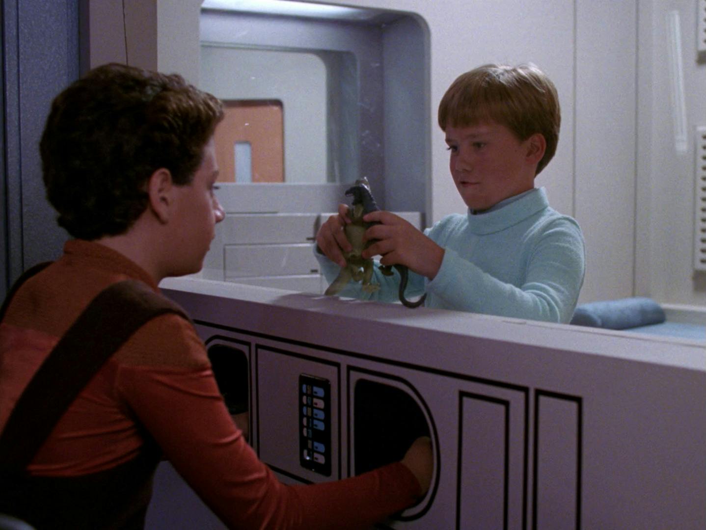 Jake and Willie Potts reconcile as the younger plays with his action figure while quarantined in Sickbay following a brotherly prank gone wrong in 'Brothers'