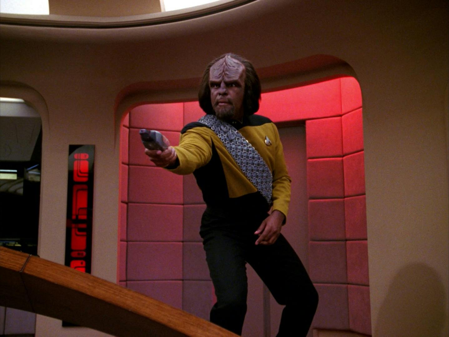 Worf rushes to his phaser pointing towards a Borg member who transports onto the bridge of the Enterprise-D in 'The Best of Both Worlds'