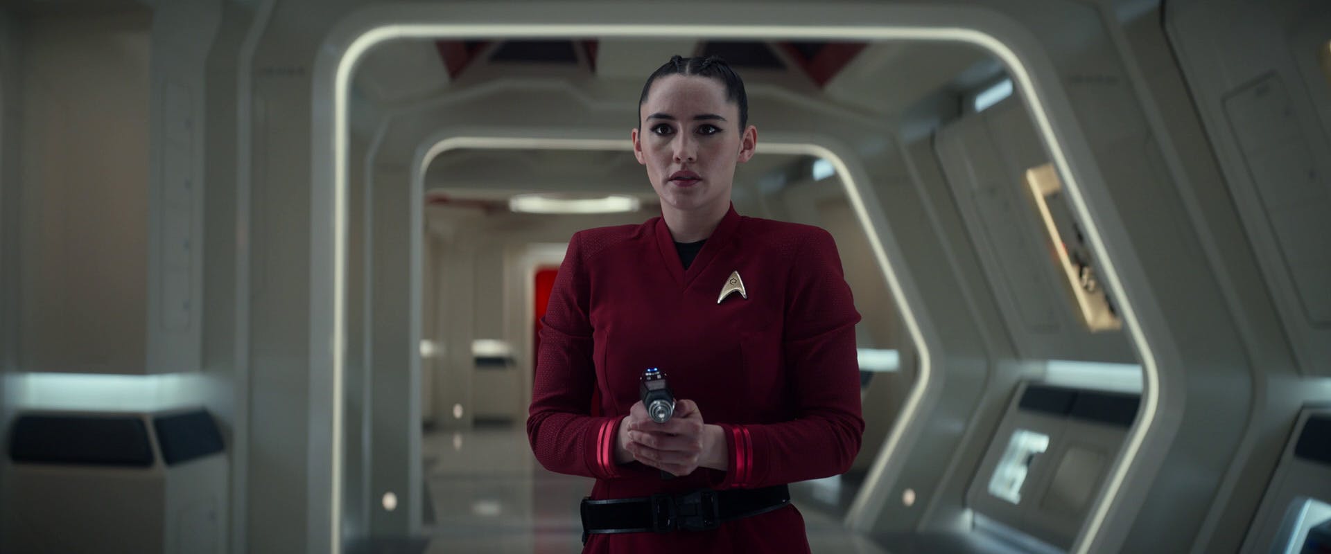 In the corridor of the Enterprise, La'An grips her phaser in 'Spock Amok'