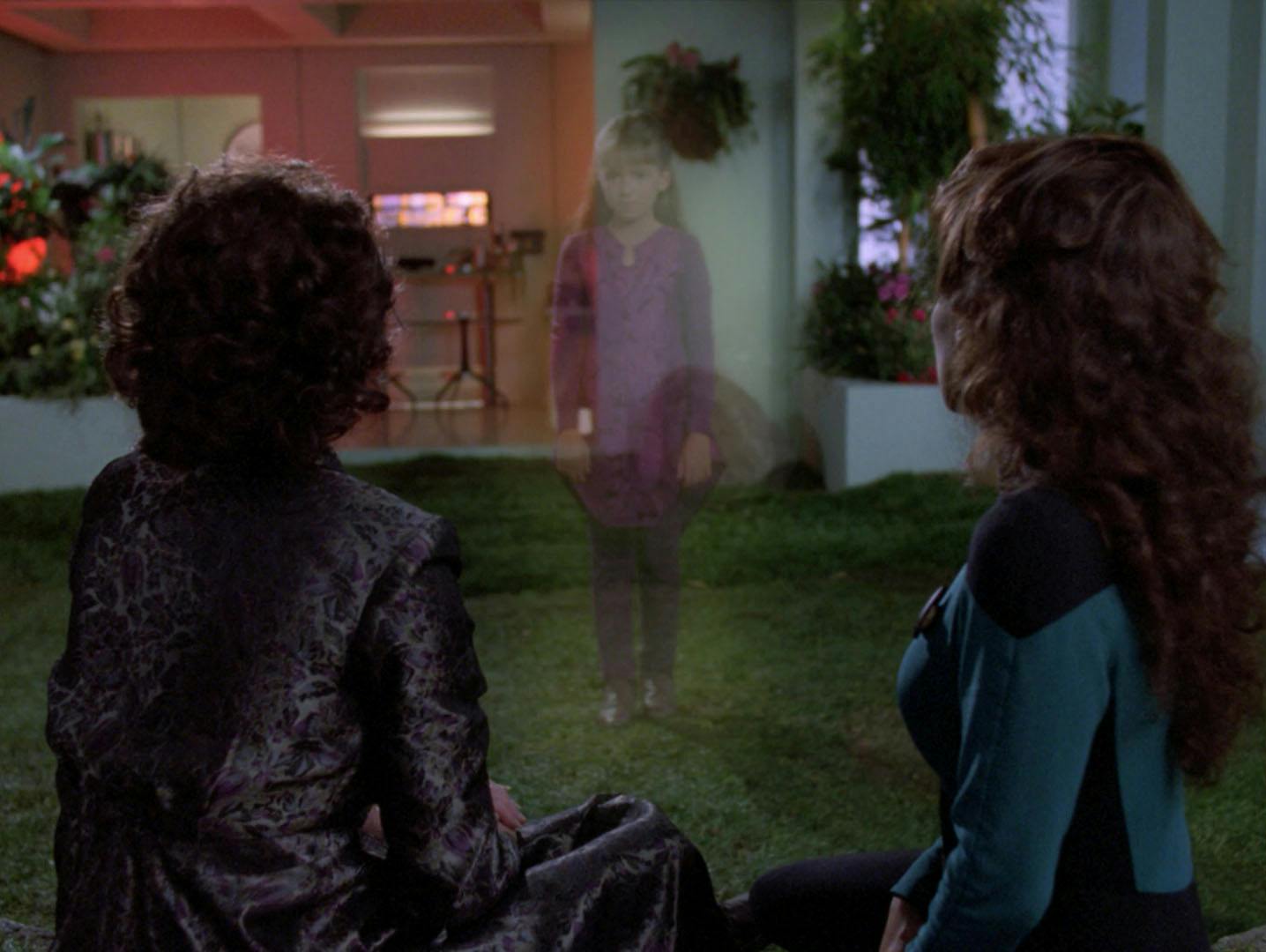 Lwaxana and Deanna Troi sitting in the Enterprise-D's arboretum look at an illusion of the deceased young Kestra Troi in 'Dark Page'