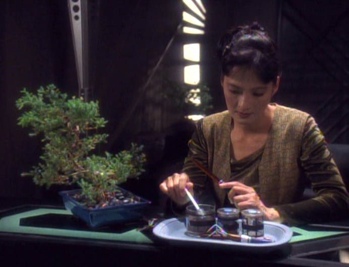 Keiko O'Brien studies her bonsai plant in the O'Briens quarters in 'The House of Quark'