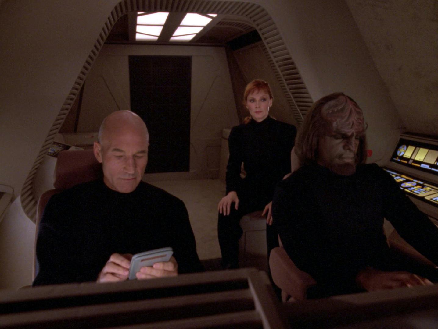 Aboard the shuttlecraft Feynman, donning black operative uniforms, Picard, Worf, and Dr. Crusher are reassigned from the Enterprise to a secret mission in 'Chain Of Command, Part I'