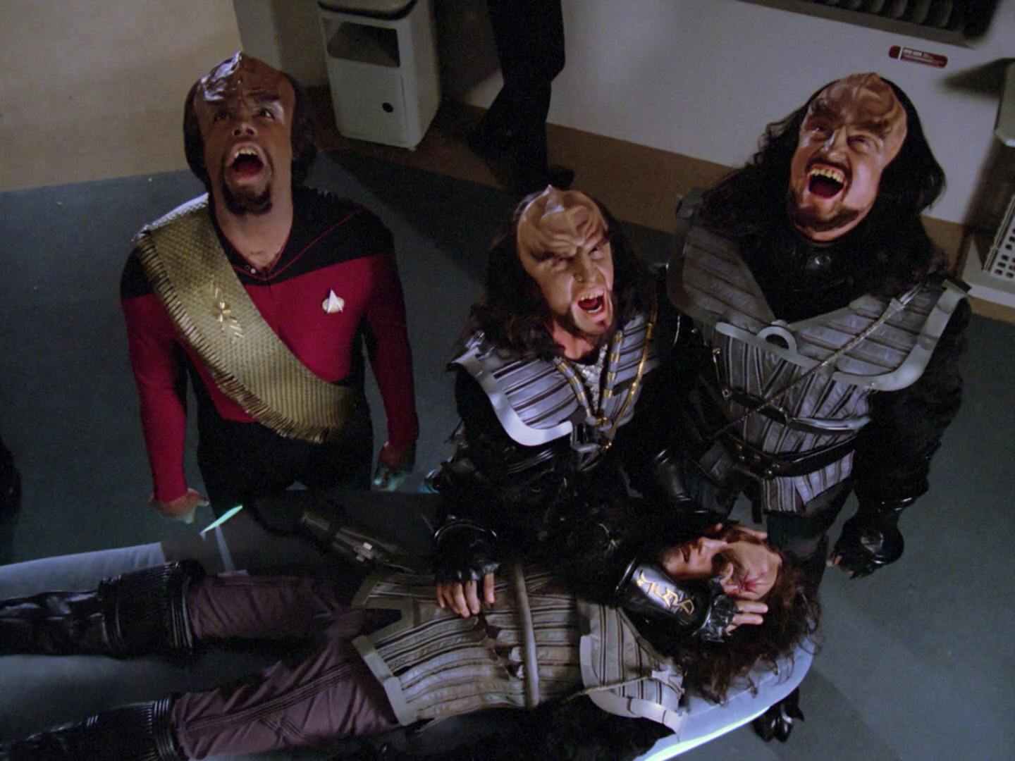 Worf and other Klingons observe a death ritual in which they stare into the eyes of a recently deceased Klingon to confirm their death before unleashing a deep bellow toward the sky in 'Heart of Glory'