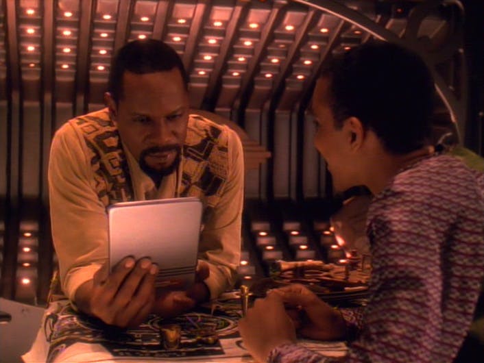 Ben Sisko reads some of Jake's writing as he watches his father's expression in 'Explorers'