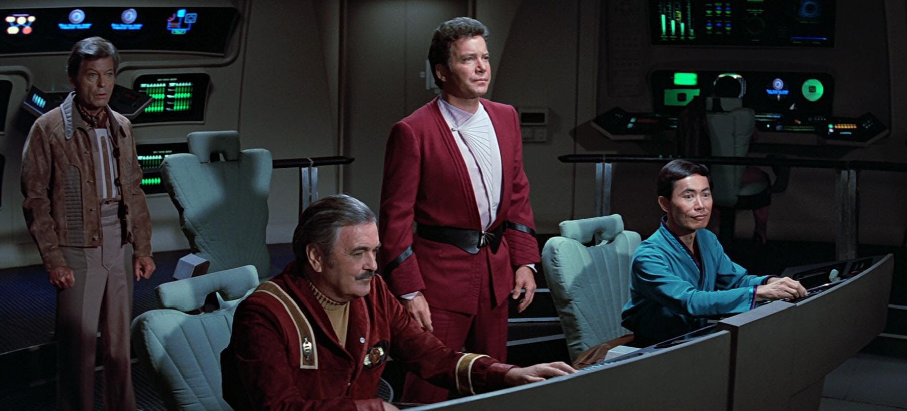 Kirk stands between Scotty and Sulu at their stations facing forward as McCoy stands behind them as they steal the Enterprise in The Search for Spock