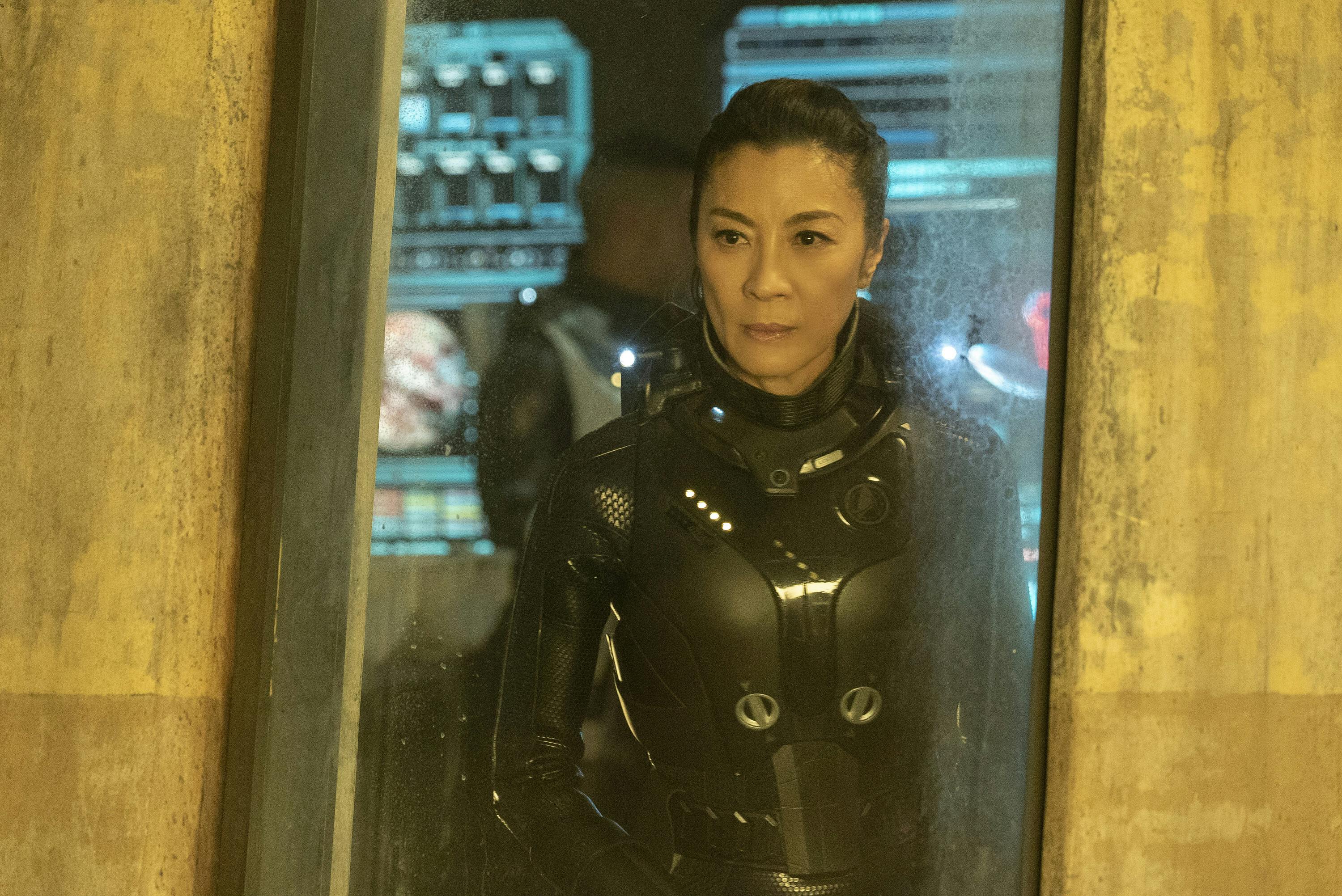 Philippa Georgiou stands behind a glass expressing concern for Michael Burnham who is using herself as bait to lure the Red Angel