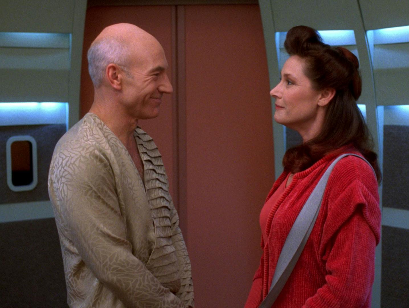 In civilian attire, Jean-Luc Picard and Nella Daren romantically smile at one another in the turbolift in 'Lessons'