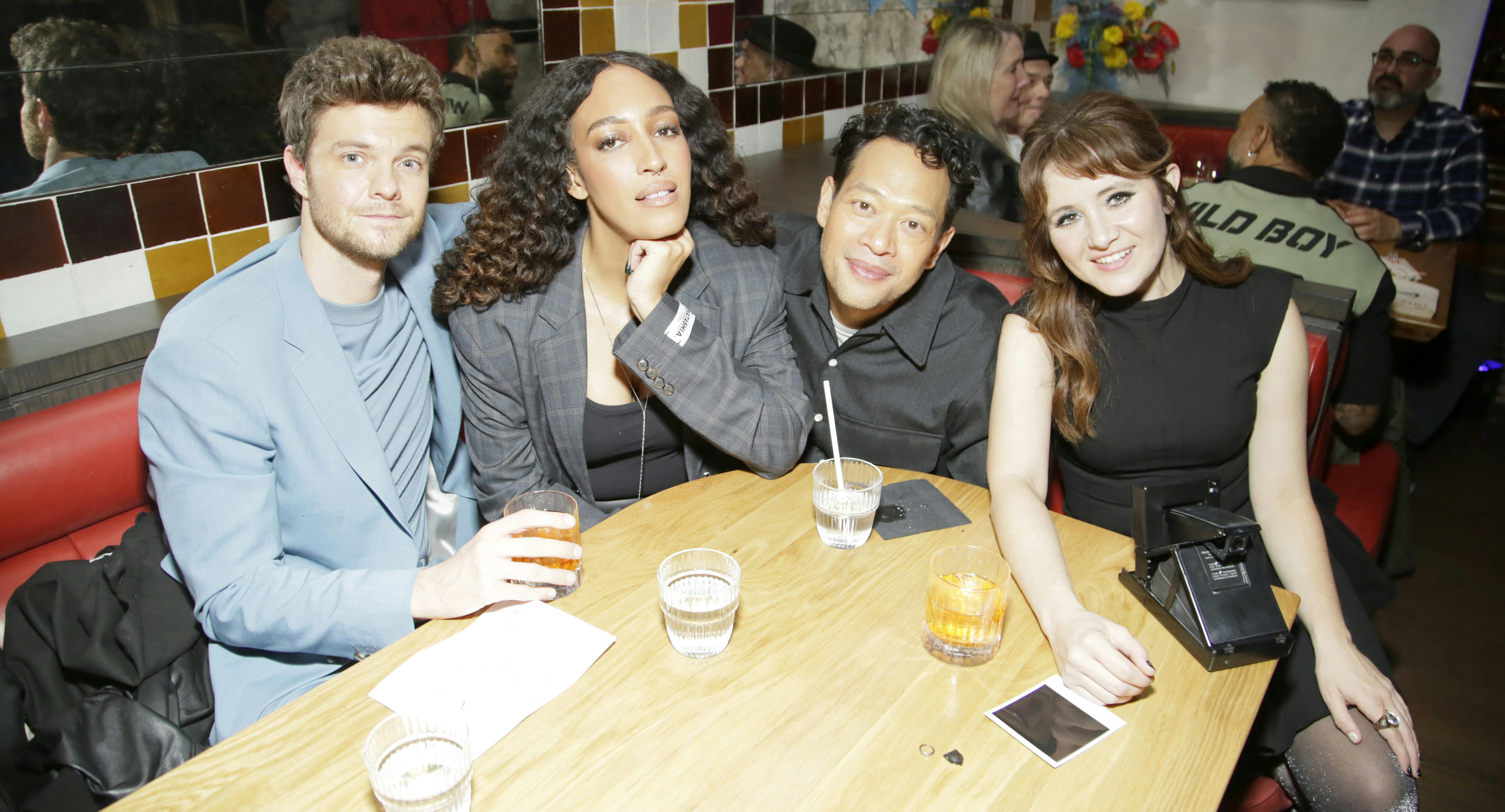 Lower Decks cast Jack Quaid, Tawny Newsome, Eugene Cordero, and Noël Wells huddled up in a booth during New York Comic Con 2024