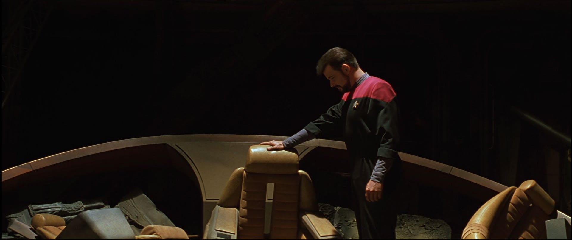 William Riker rests his hand glumly on the captain's chair of the wrecked Enterprise-D bridge in 'Star Trek Generations'