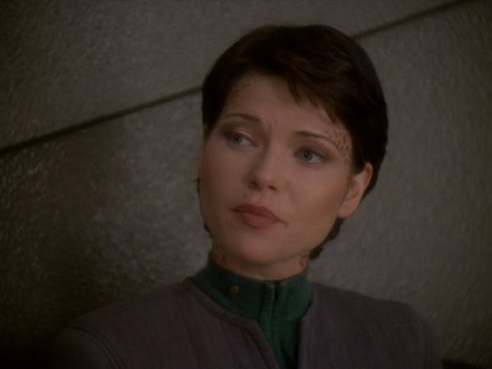 A close-up of a pensive Ezri Dax as she gazes over her right shoulder in 'Afterimage'