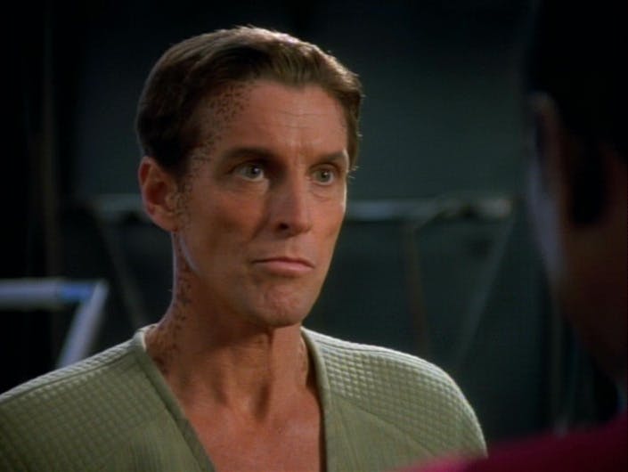 Close-up of Jerad, following his absorption of Jadzia's Dax symbiont, facing Sisko aboard the station in 'Invasive Procedures'