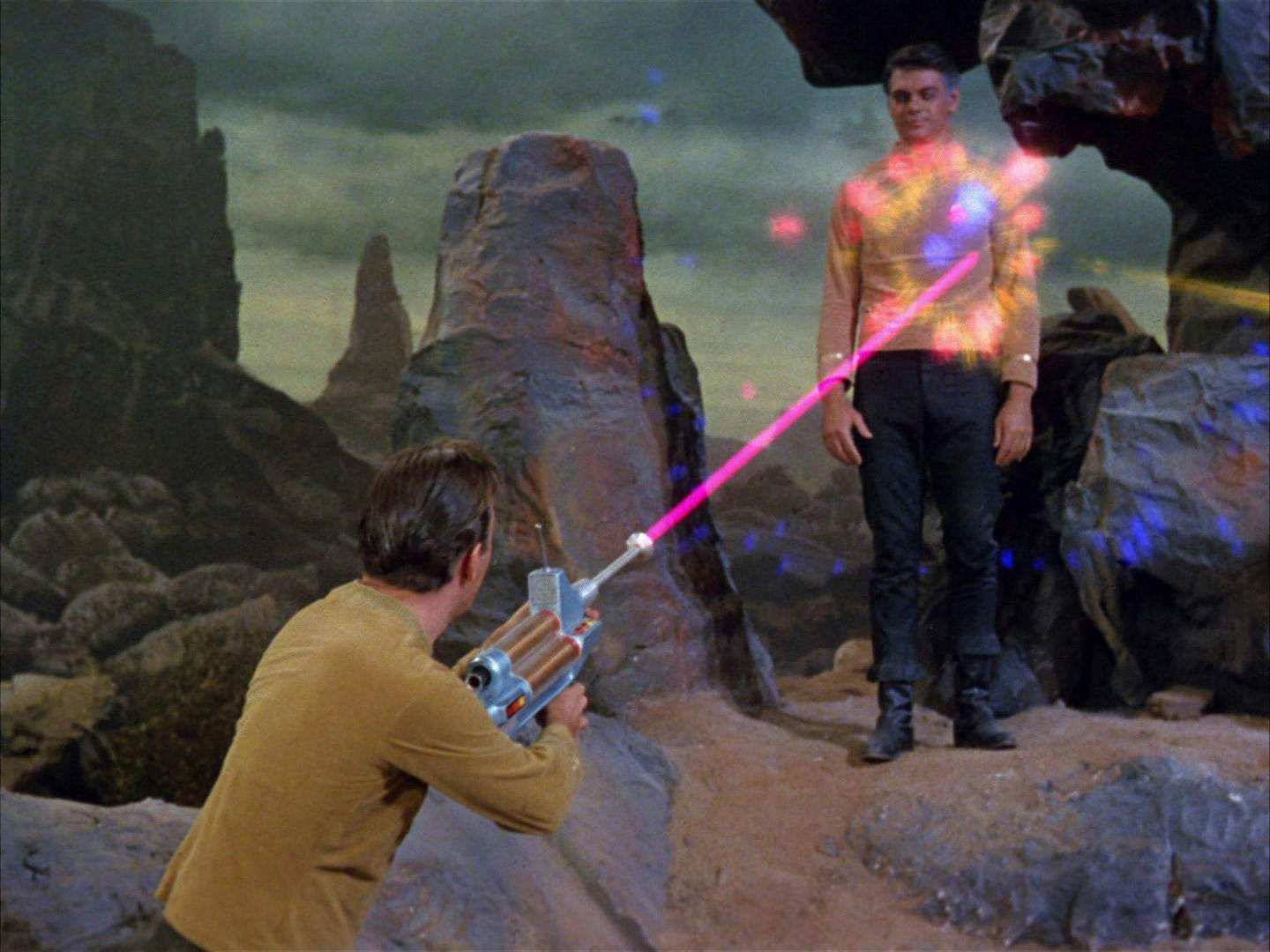 Kirk opens fire on Gary Mitchell with a phaser rifle on the surface of Delta Vega in 'Where No Man Has Gone Before'