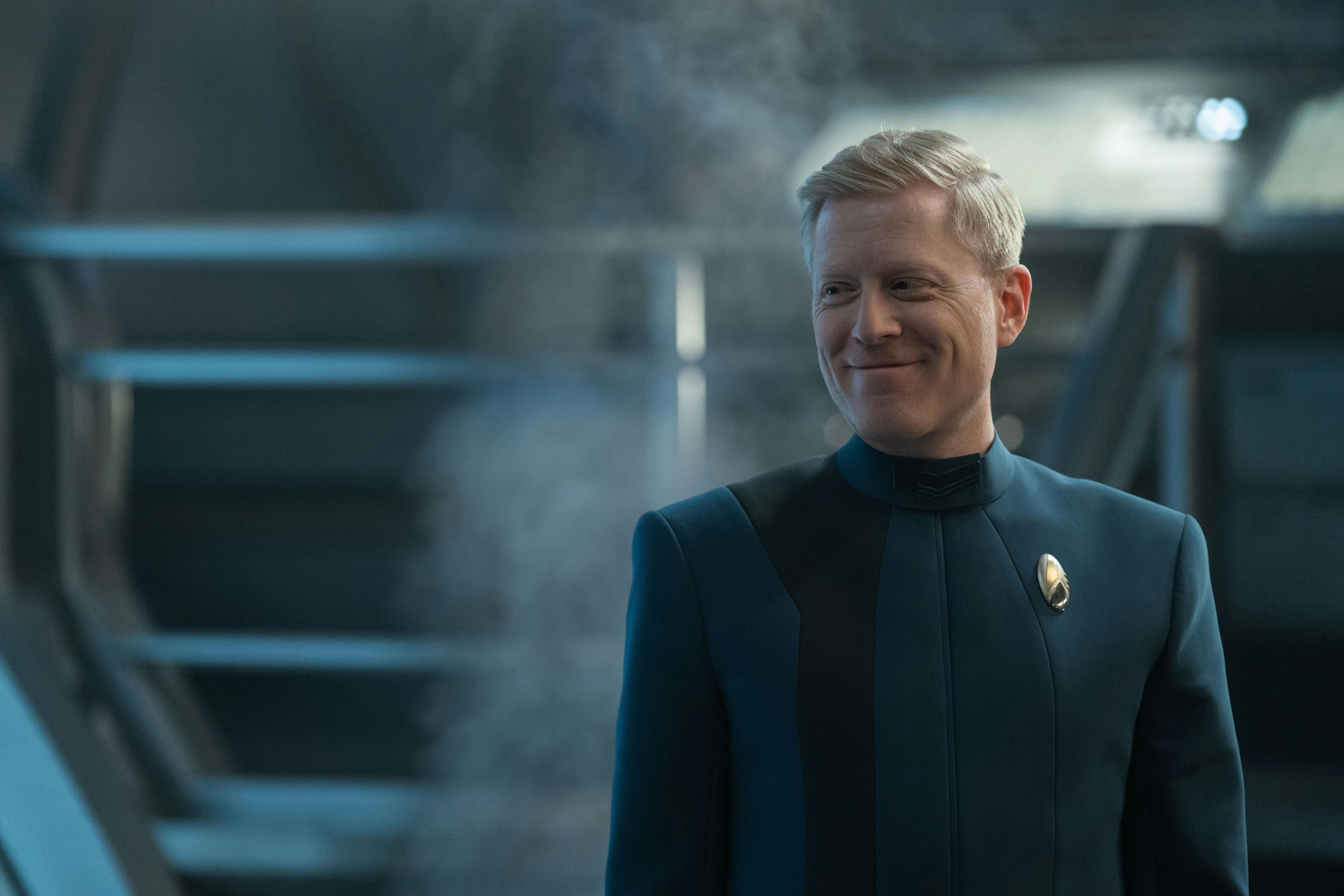 In engineering, Statmets grins while looking over his shoulder in a first look for Star Trek: Discovery Season 5