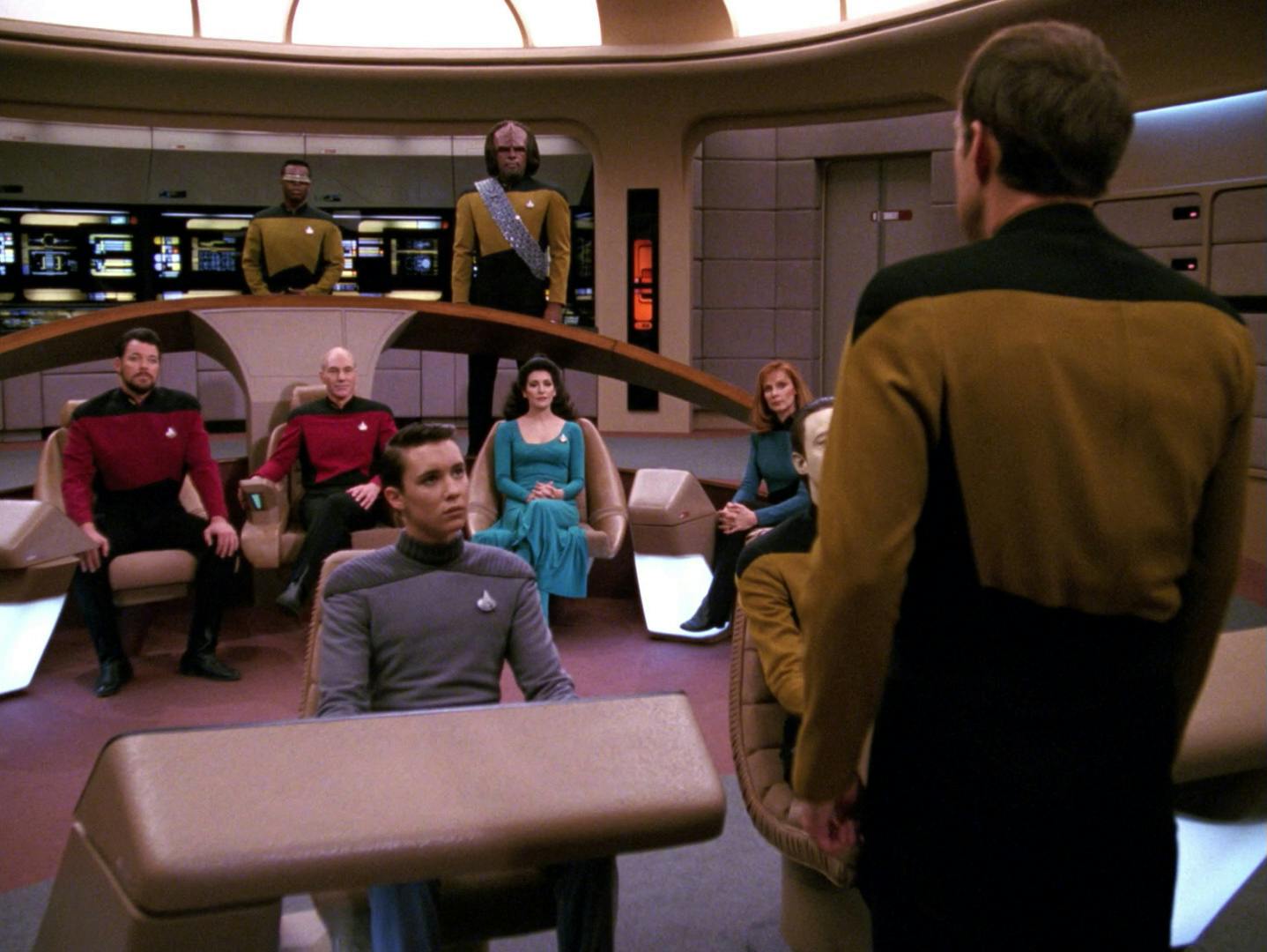 Standing between a holo-simulation of the Enterprise-D crew on the bridge, Barclay faces them as he announces he's leaving behind his holo-addiction in 'Hollow Pursuits'