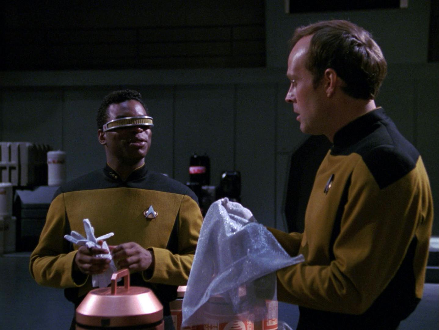 In the Cargo Bay, La Forge smiles as he looks over at Barclay, upon learning how to work with him in 'Hollow Pursuits'