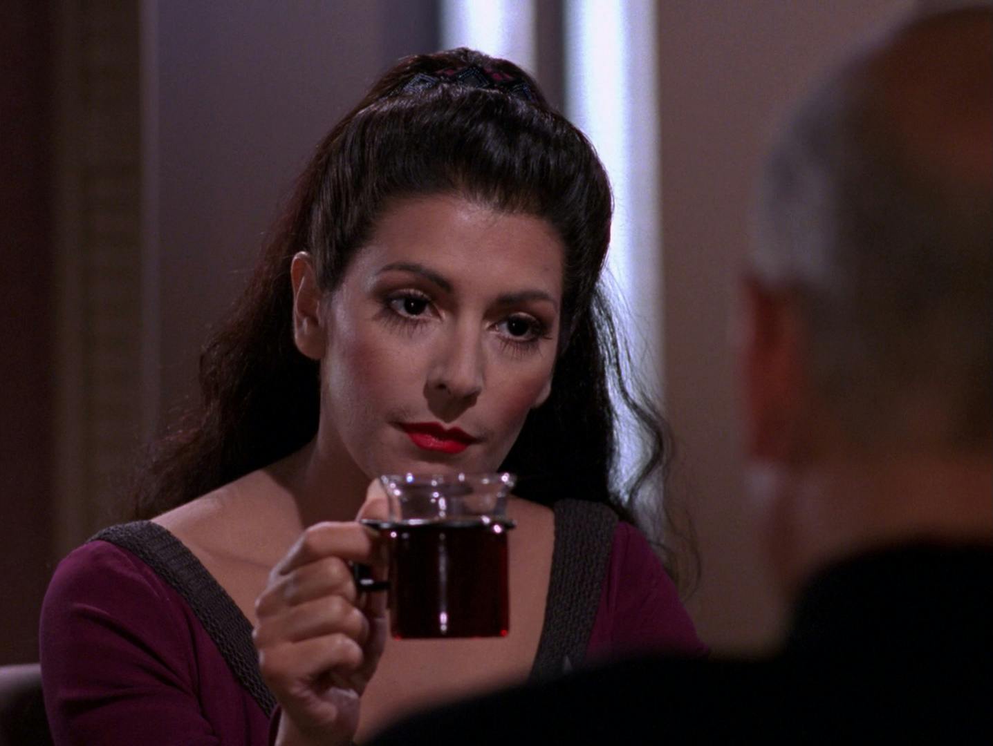 In his Ready Room, Deanna Troi lifts up her glass to Picard to make a point about language in 'The Ensigns of Command'