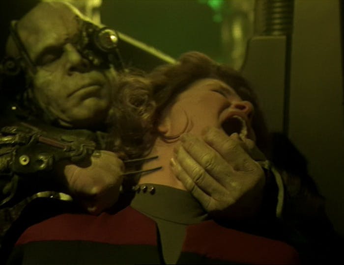 A Borg approaches and grabs Captain Janeway from behind and prepares assimilation in 'Unimatrix Zero'