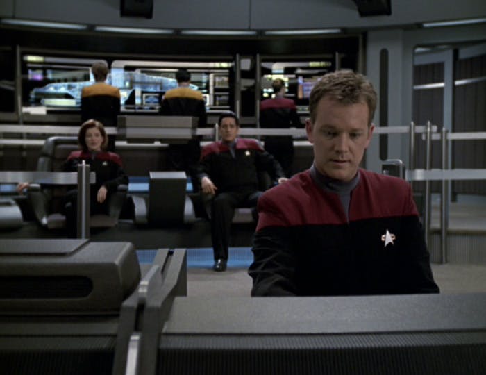 Tom Paris, Captain Janeway, and Chakotay are all seated at their stations/seats on the Voyager bridge in 'Unimatrix Zero'