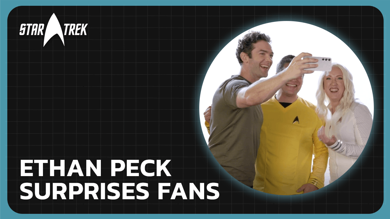 Ethan Peck takes a selfie with two fans cosplaying as Star Trek: Strange New Worlds' Captain Pike and Nurse Chapel