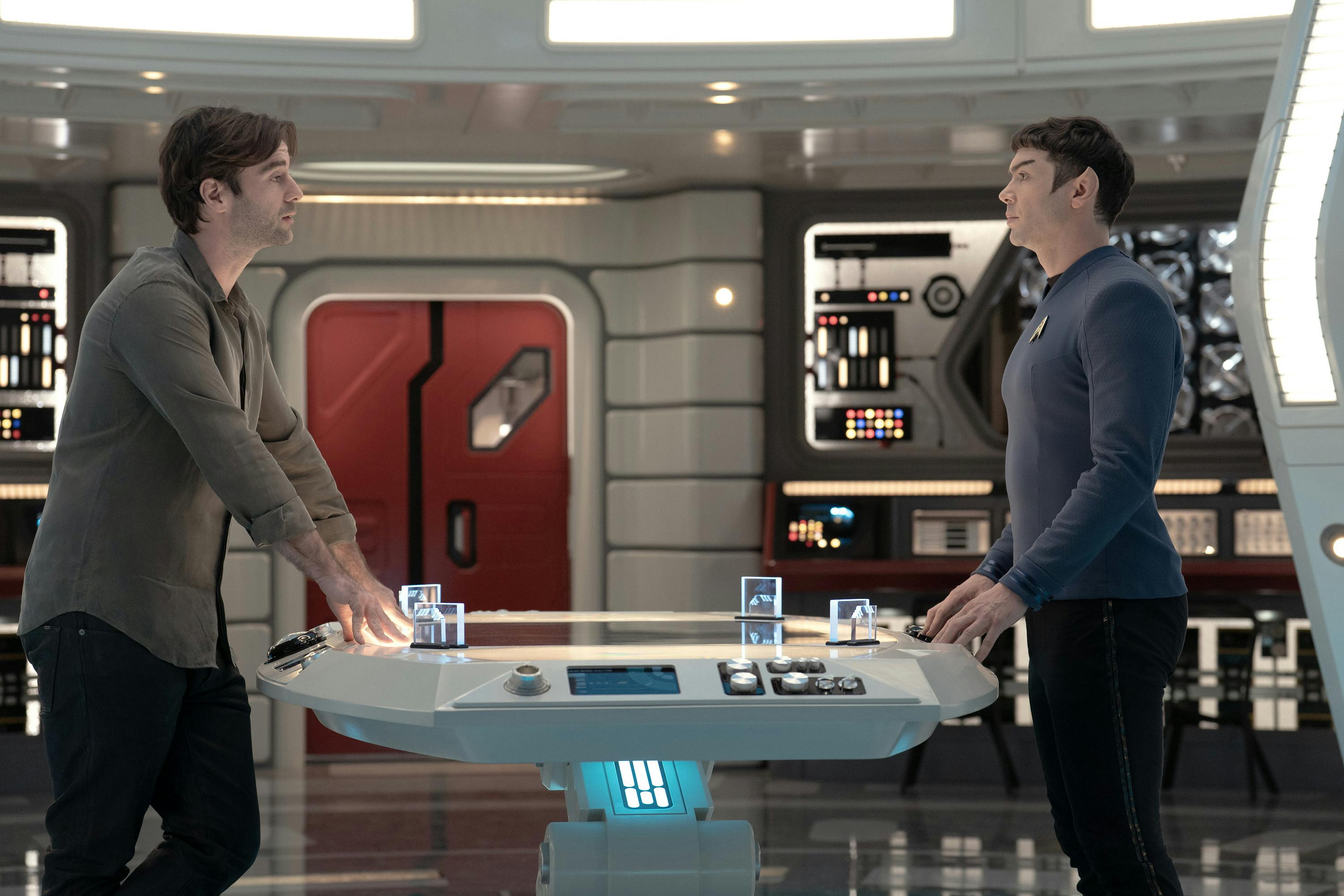 Roger Korby and Spock standing across from each other run a scan of ship passengers in the Science Lab in 'Wedding Bell Blues'