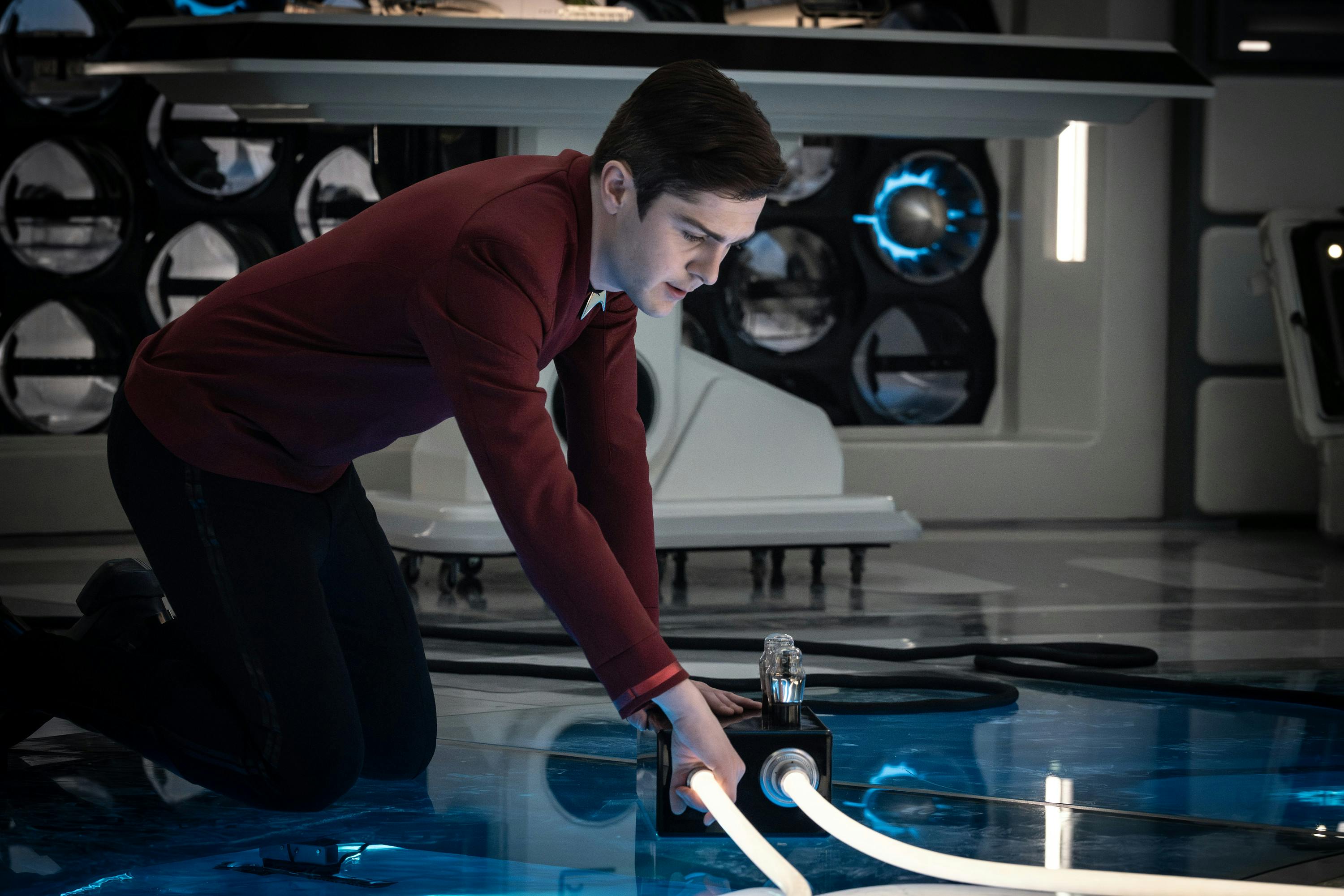 Scotty performs an inspection of equipment while on his knees in Engineering in 'A Space Adventure Hour' 