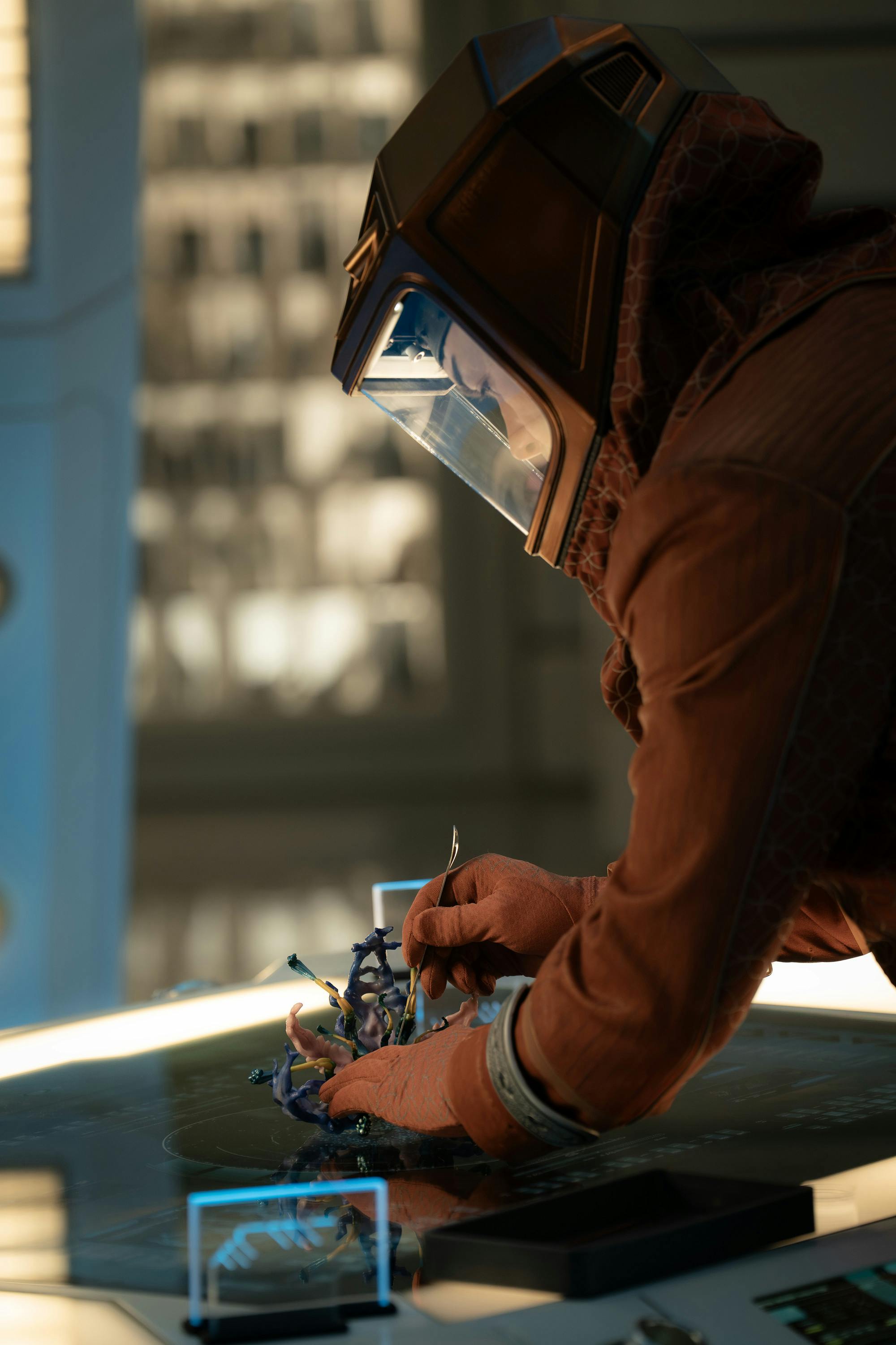 Spock in an EV suit dissects a Chimera blossom in the Science Lab in 'Shuttle to Kenfori'