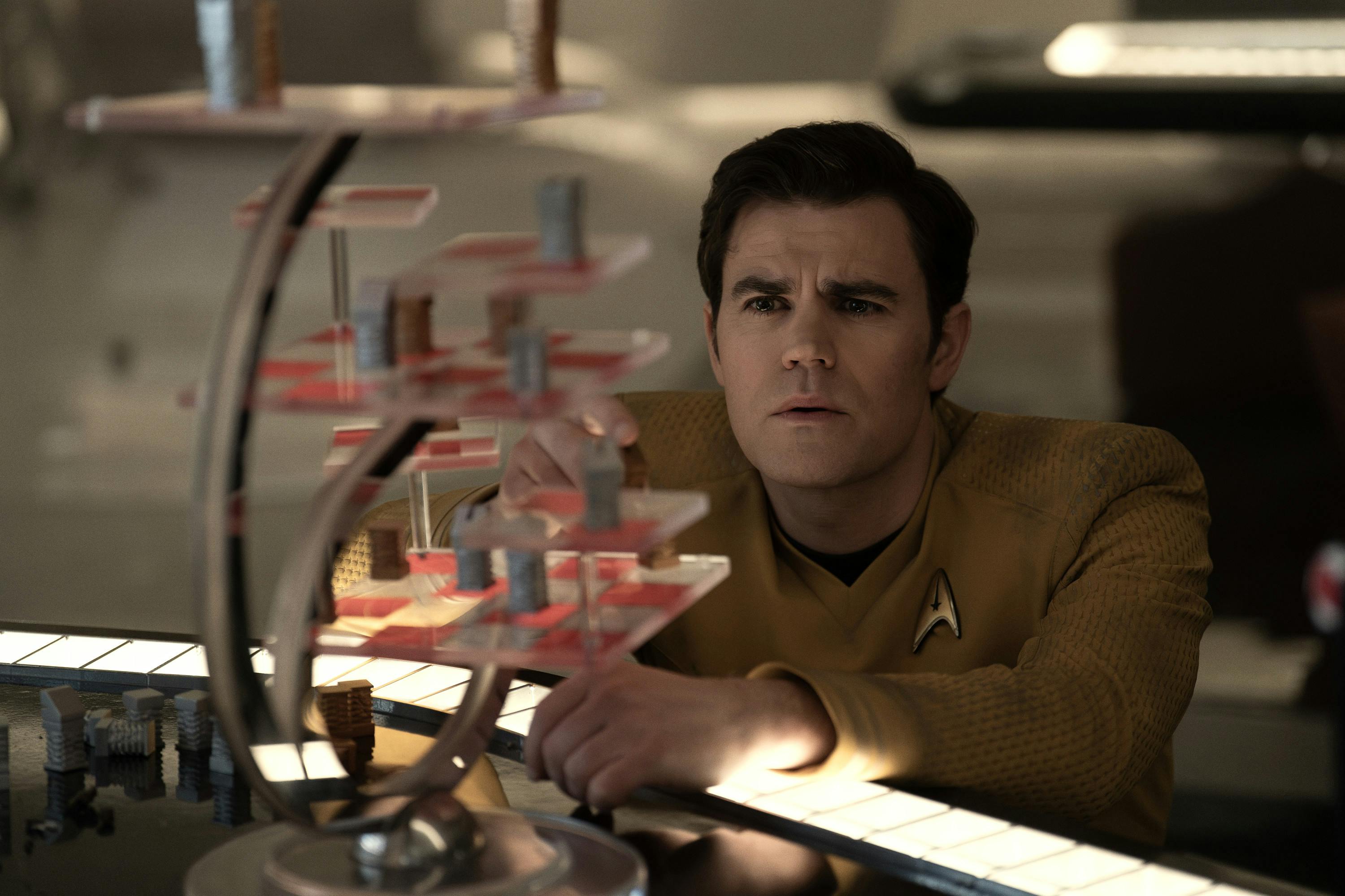In the Farragut Ready Room, James T. Kirk crouches beside a 3D chess set in 'The Sehlat Who Ate Its Tail'
