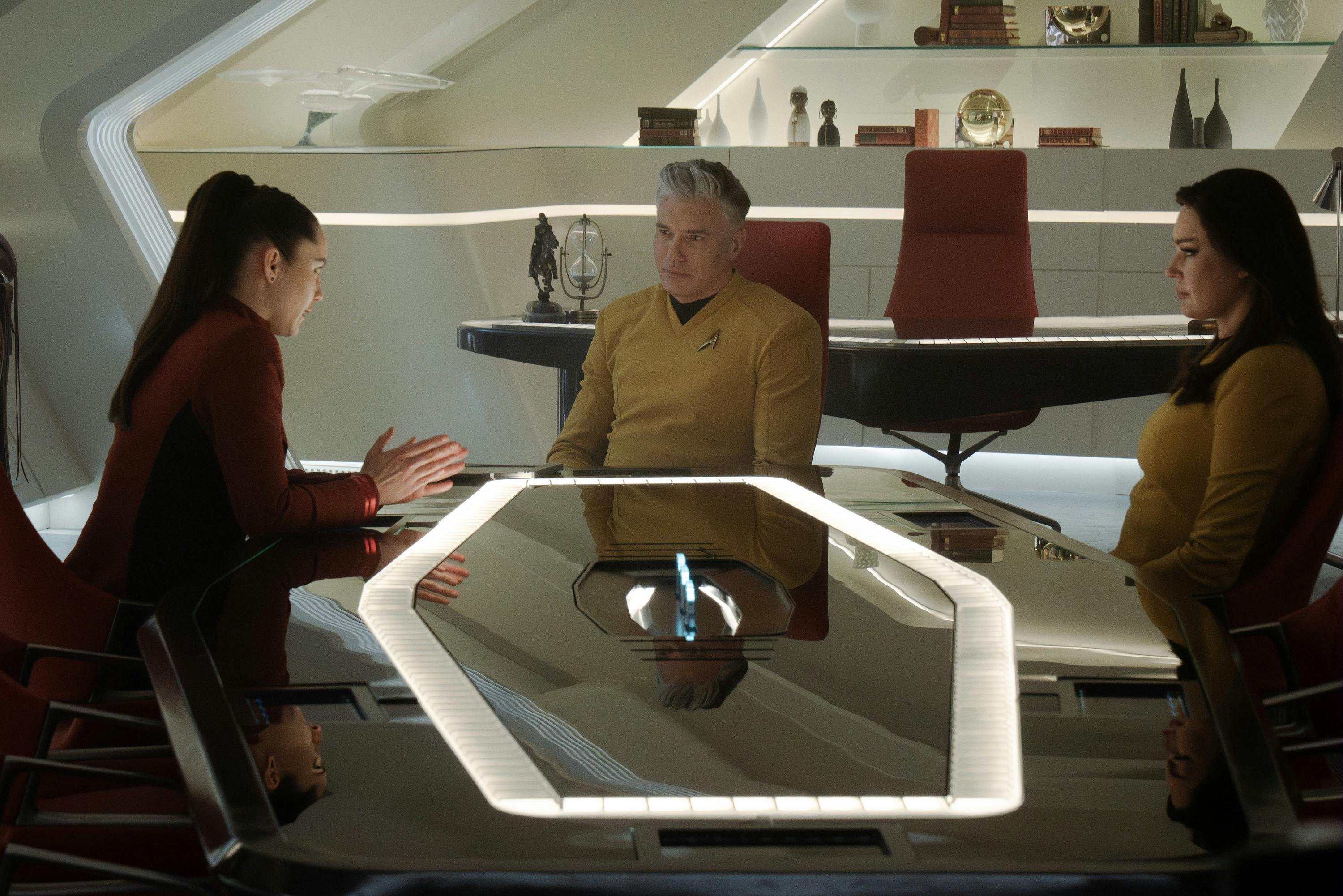 La-An, Captain Pike, and Number One sit around the conference room table in the Ready Room in 'A Space Adventure Hour'