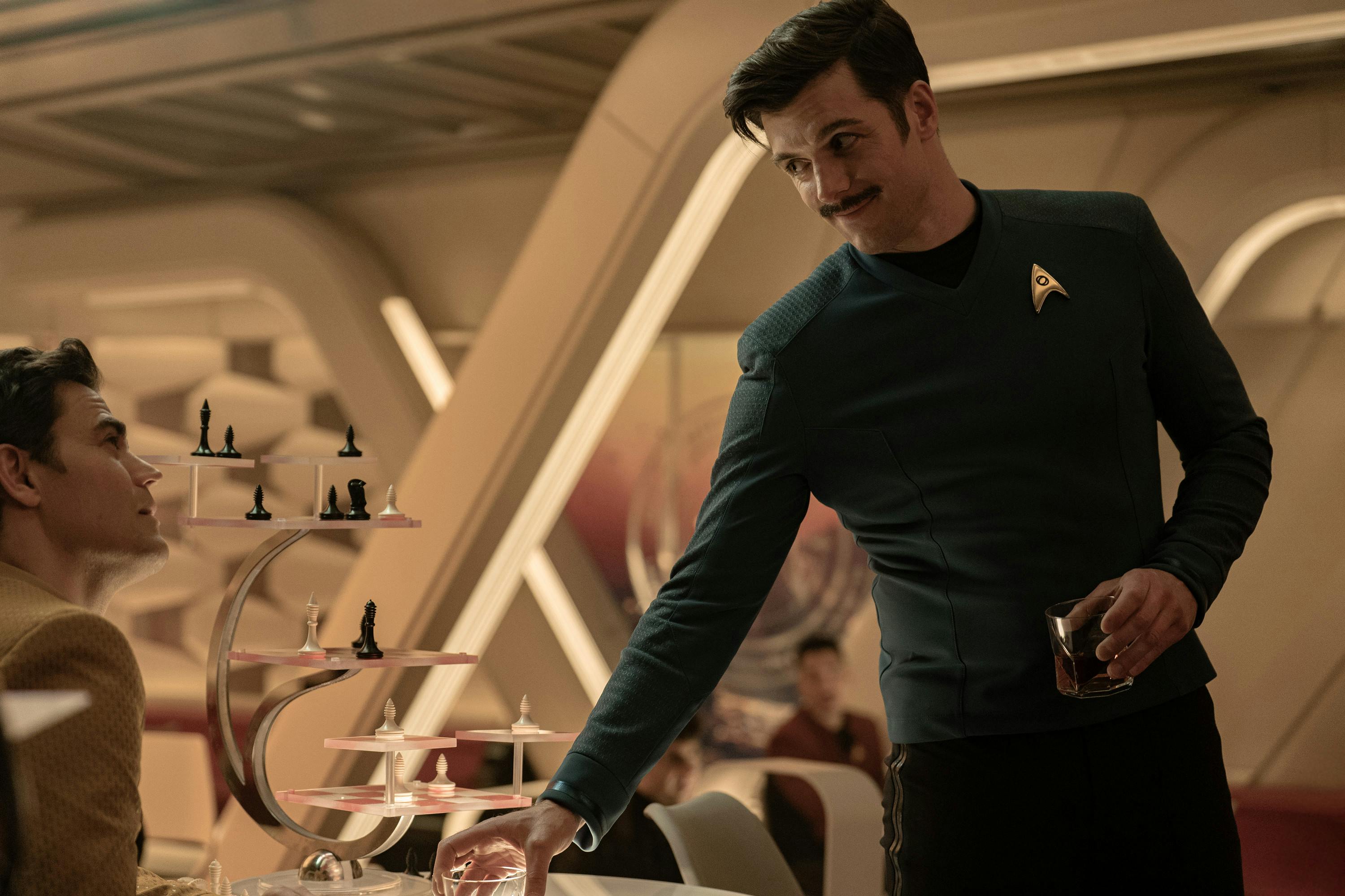 Sam Kirk approaches the seated James T. Kirk in the Port Galley in 'New Life and New Civilizations'
