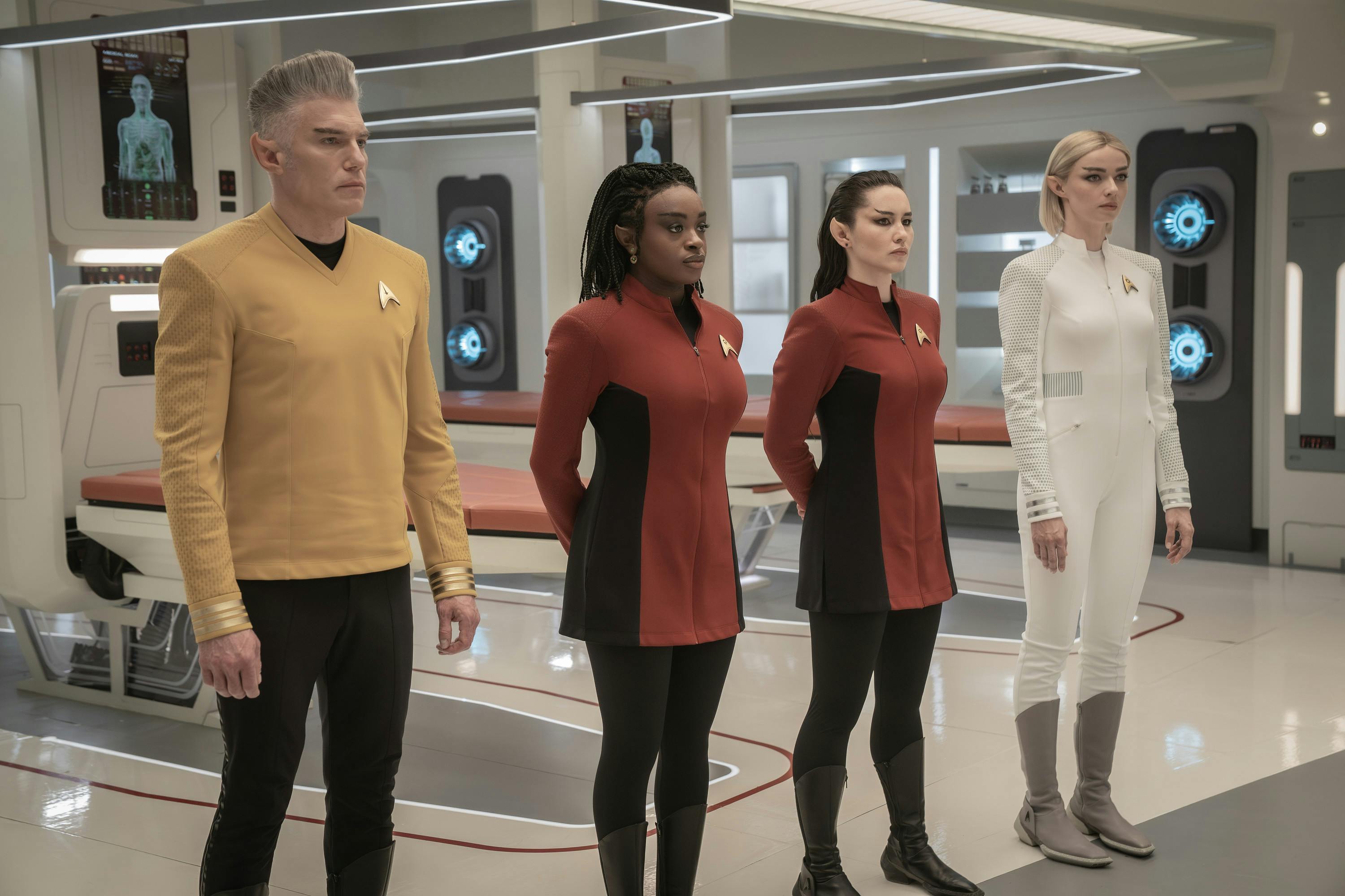Vulcan Pike, Uhura, La'An, and Chapel stand at the ready in Sickbay in 'Four-and-a-Half Vulcans'