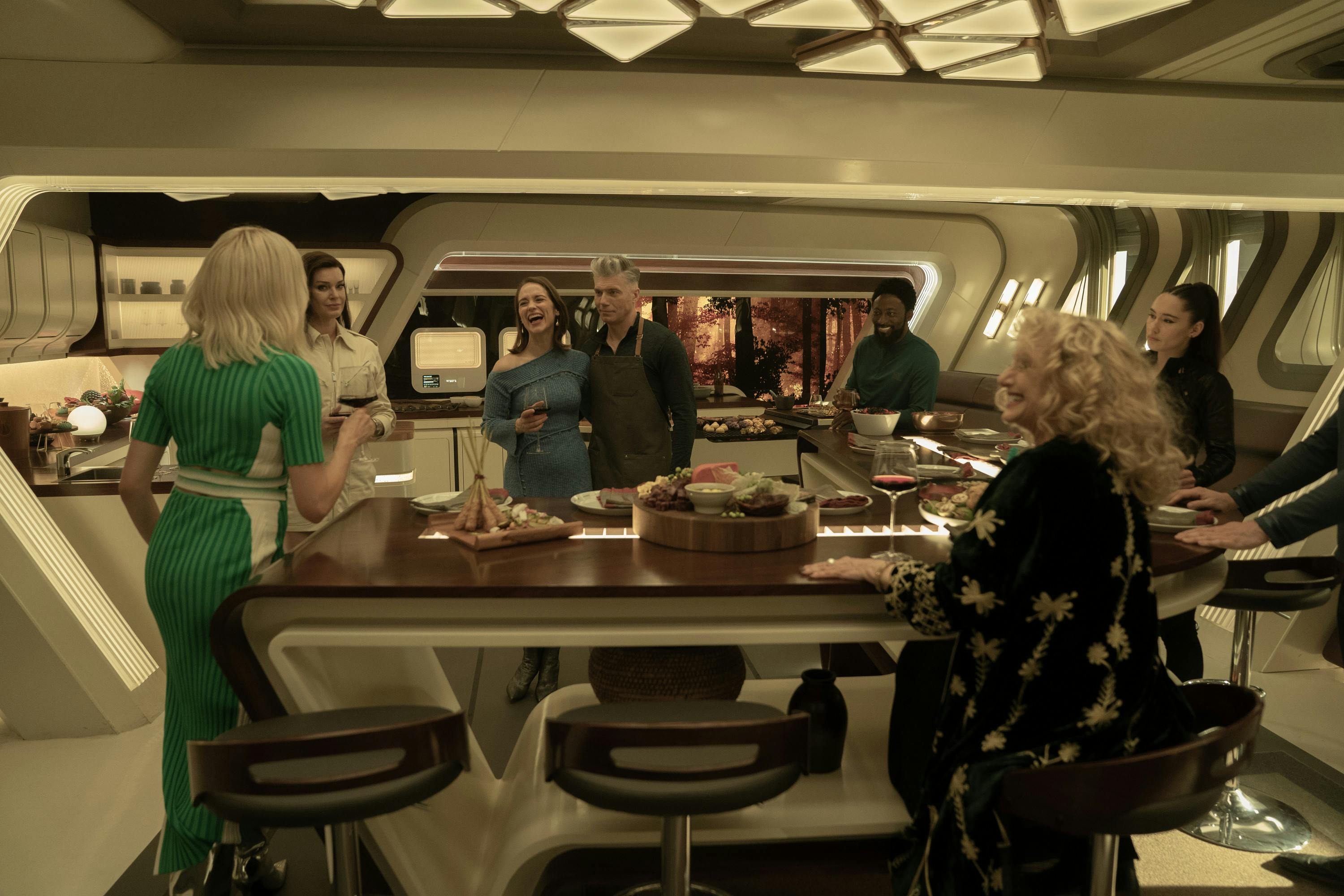 The crew celebrates Batel's promotion over dinner in captain's quarters in 'New Life and New Civilizations'