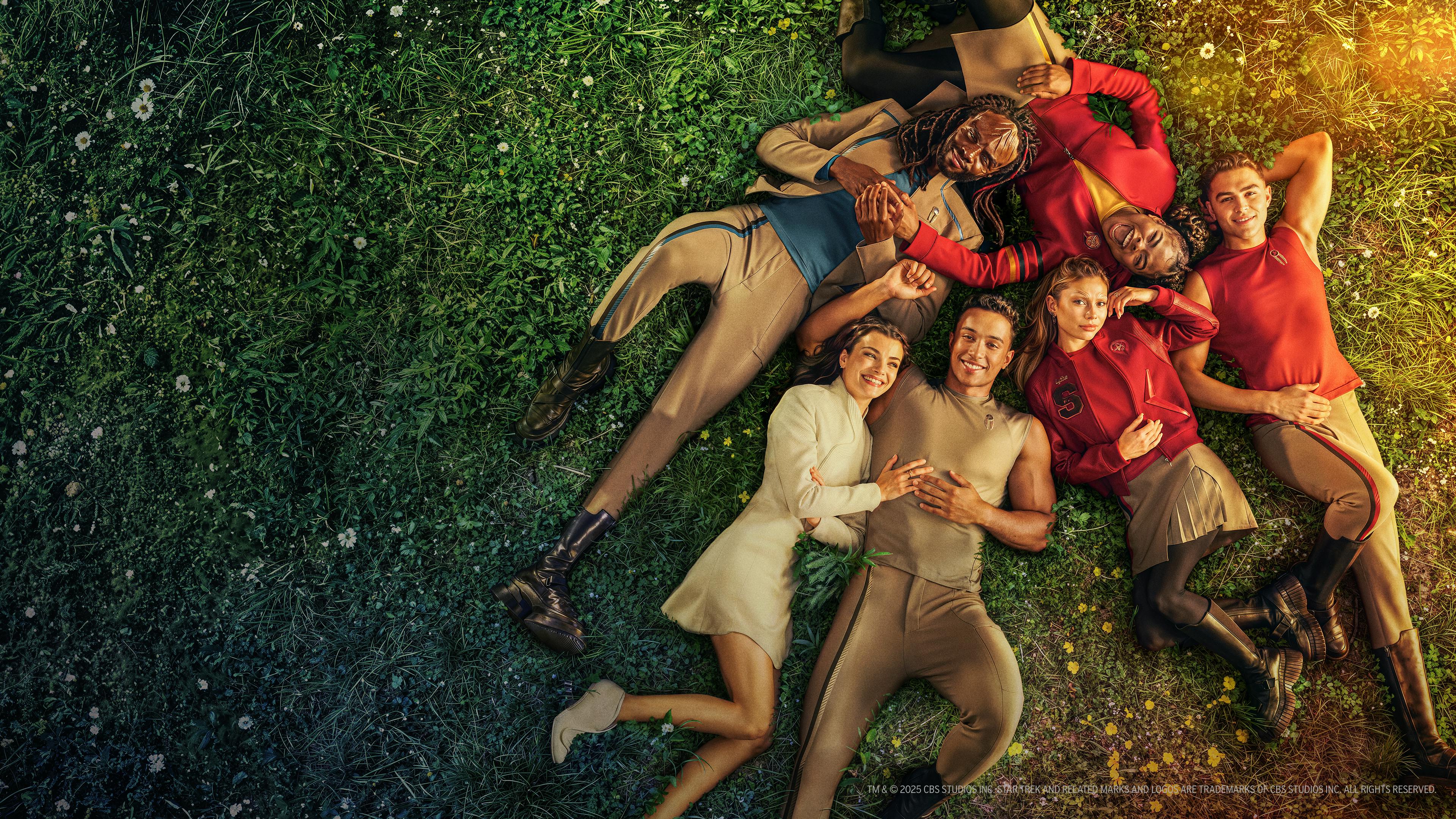 Starfleet Academy key art with cadets laying in a group on grass