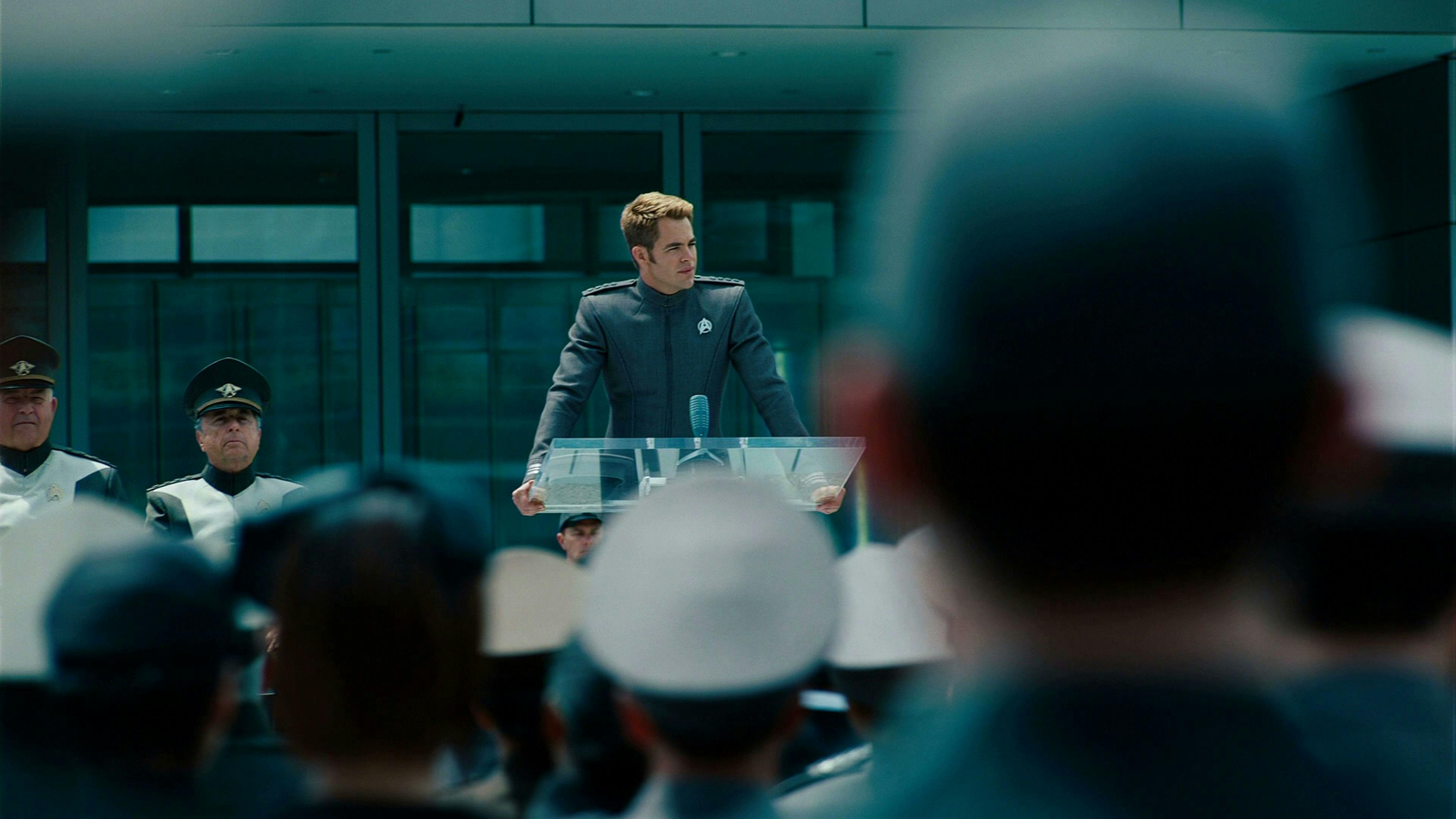Speaking at the podium at the U.S.S. Enterprise rechristening ceremony, James Kirk address the crowd in Star Trek Into Darkness
