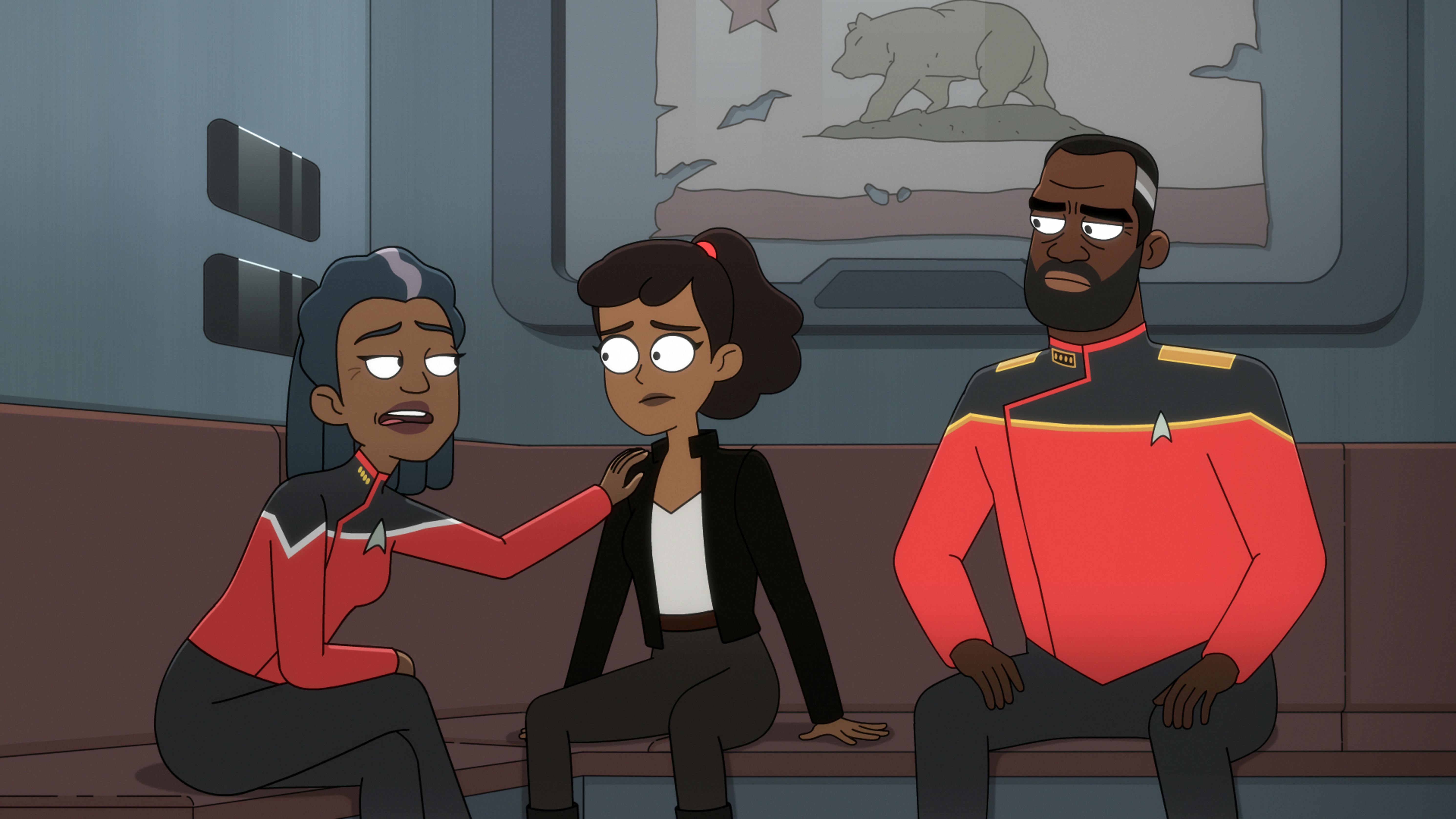 Mariner sits between her parents Captain Carol Freeman, who rests her hand on her shoulder, and Admiral Freeman in 'Grounded'