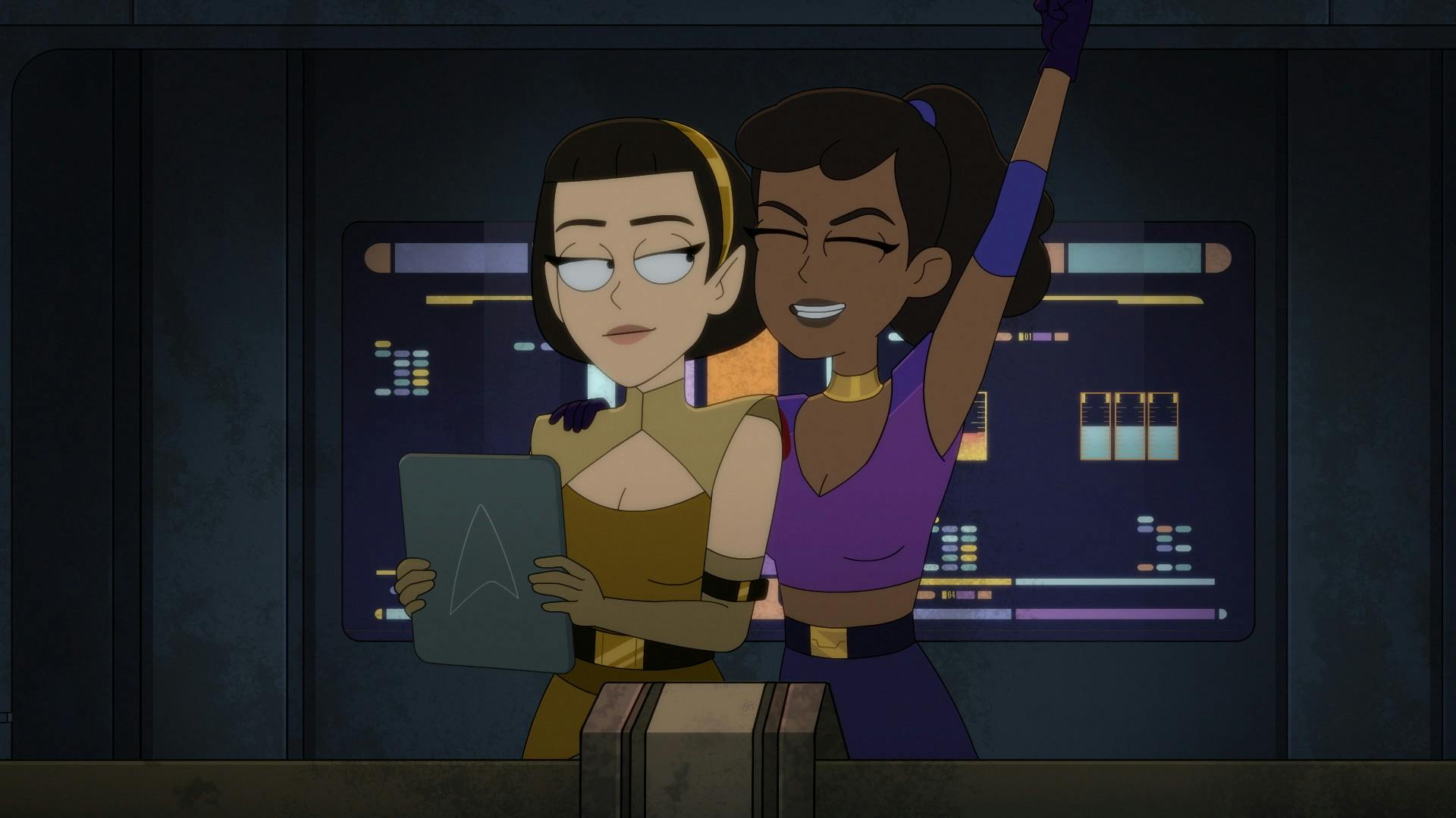Wearing Orion gear, Mariner pulls T'Lyn in for a side hug as she raises her arm in cheer while T'Lyn displays an upward smirk while holding her PADD in 'Something Borrowed, Something Green'