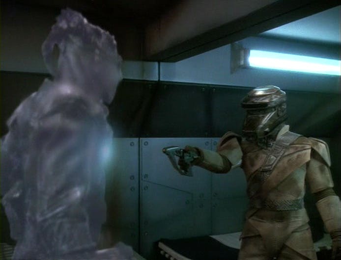A Breen prisoner raises his phaser at a Jem'Hadar guard in 'By Inferno's Light'