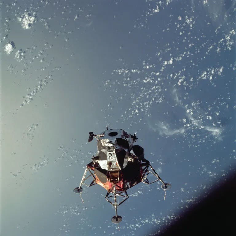 A view of the Apollo 9 Lunar Module (LM), nicknamed “Spider,” in a lunar landing configuration, as photographed from the Command and Service Modules on the fifth day of the Apollo 9 Earth-orbital mission. The landing gear on the LM has been deployed. Lunar surface probes (sensors) extend out from the landing gear.