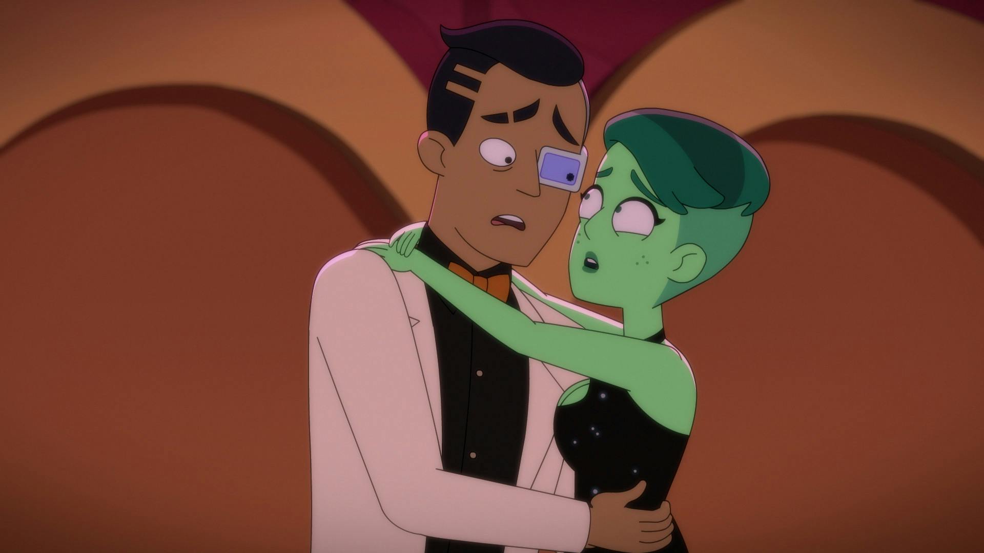 Masquerading as recent newlyweds, an uncomfortable Rutherford and Tendi with her arms around his neck, both freaked that their cover is blown in 'Parth Ferengi's Heart Place'
