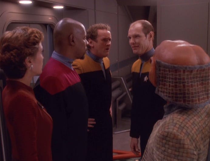 Kira Nerys, Ben Sisko, and Miles O'Brien rematerialize on the Defiant in front of Rom and Eddington in 'Our Man Bashir'