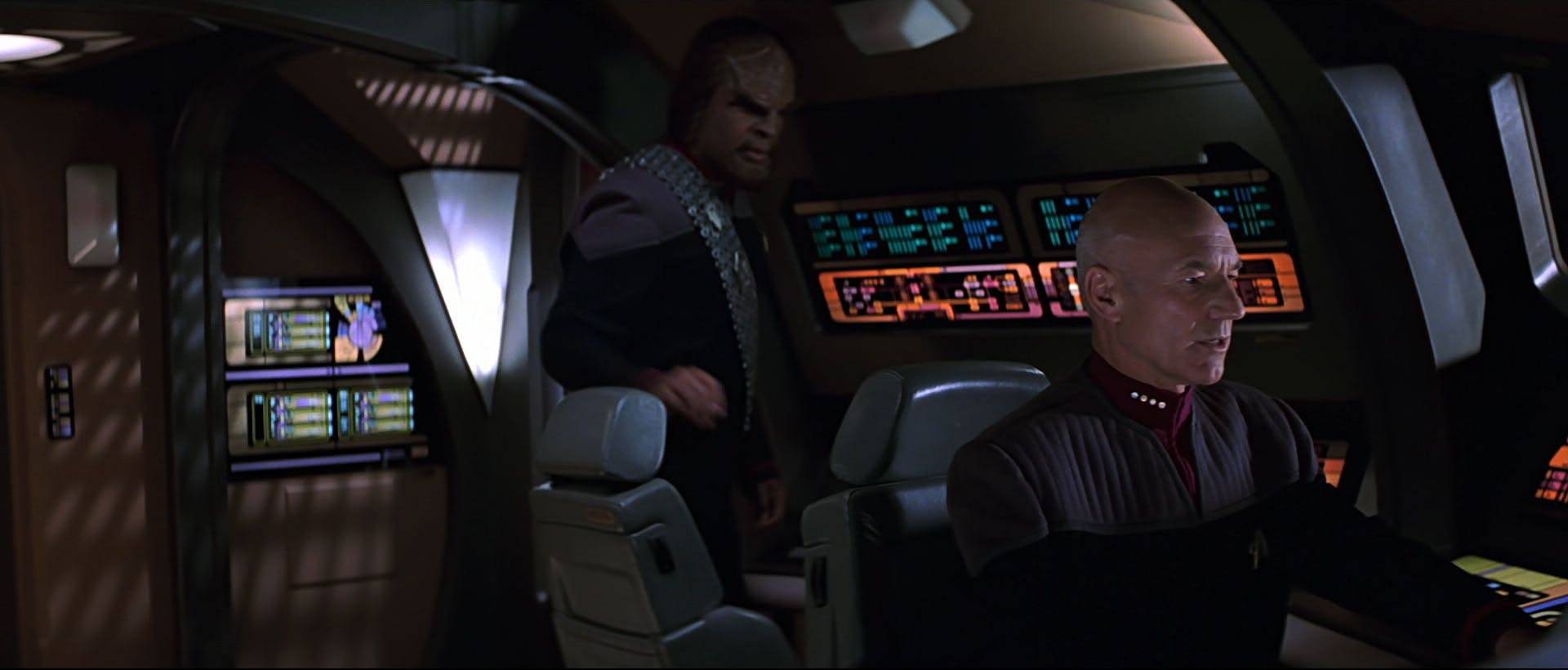 Worf approaches as Captain Picard is at the helm of an Enterprise shuttle in Star Trek: Insurrection